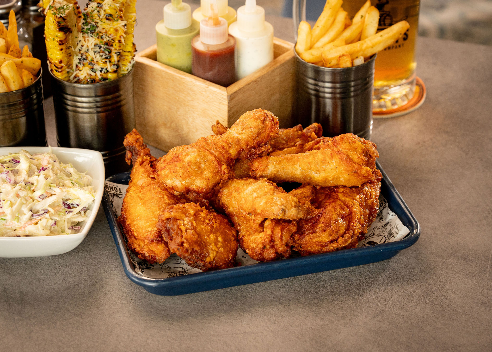 Fried chicken, fries, corn, and Tommy's beer